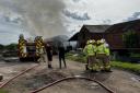 Firefighters tackle a blaze at a farm on Hall Drive
