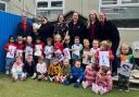 Staff and children at Little Angels celebrating being graded 'Good' in their latest Ofsted report