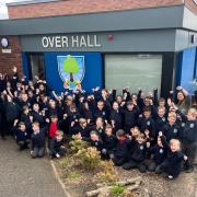 Pupils and staff at Over Hall  Community School  celebrating their most recent Ofsted grade