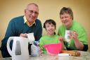 Mary Cooper’s cake stall proved a hit with Moulton residents. Mary is pictured with her dad Alan and mum Sharon.