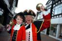 Town crier David Mitchell and his son and apprentice Spencer, eight, proclaim the achievements of Mid-Cheshire College.