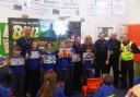 Year Six Moulton Primary School pupils, Paul Davis, from the council’s Streetscene service, PCSOs Kat Stock and Steve Bishop, Clr Helen Weltman, and community safety wardens Alan Melbourne and Pete Harding.