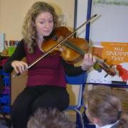 Fiona Petersen plays the viola to some Year Seven children at Rosebank School.