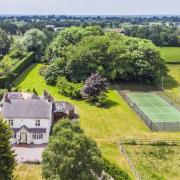 An aerial view of the property and tennis court (Savills)