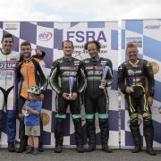 Pete Founds, fourth from left, and his passenger Jevan Walmsley, third from left, on the podium after winning race two in the British F2 Championship at Oulton Park. Picture: Ste McNorton