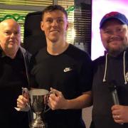 Greg Smith, centre, being presented with the Castle Classic Trophy by Adi Faulkner, competition organiser, right; and Tim Shaw, tournament sponsor from Northwich Carpets & Laminates, left