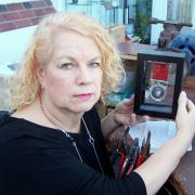 Yvonne Chadderton and her commemorative medal.