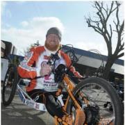 Adrian Derbyshire shows off his hand cycle.