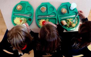 Photo via PA shows children eating school meals.