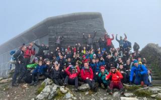 Scouts and their leaders from groups across Mid Cheshire celebrating their ascent of Snowdon last October