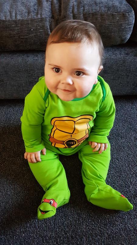 This is baby Swayze Lumsden, age 9 months. He enjoyed his first World Book Day at Northwich Library, dressed as a Ninja Turtle