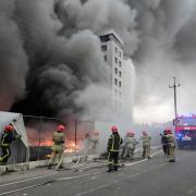 Firefighters work to extinguish a fire at a damaged logistic centre after shelling in Kyiv, Ukraine (Efrem Lukatsky/AP)