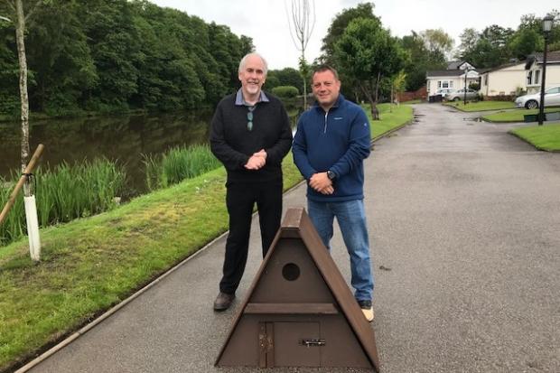 John Mycock, chairman of the Mid Cheshire Barn Owl Conservation Group, and one of Riverside Park's owners Darren Jones with the birdbox 