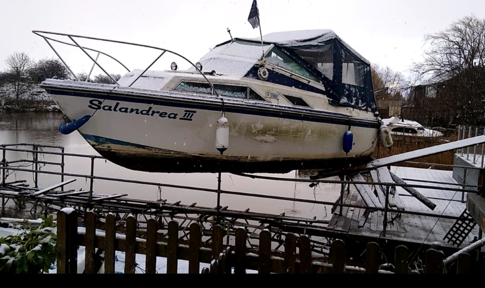 This motor launch was left marooned sitting on railings nine feet above the river