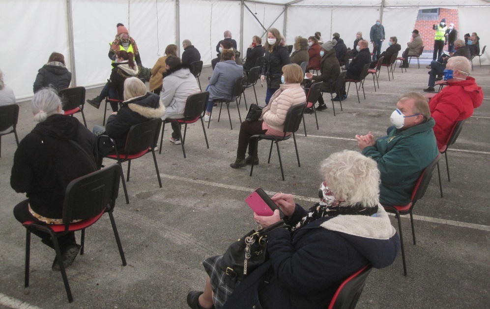 Patients are asked to sit and wait for 15 minutes in a marquee after receiving the Pfizer vaccine