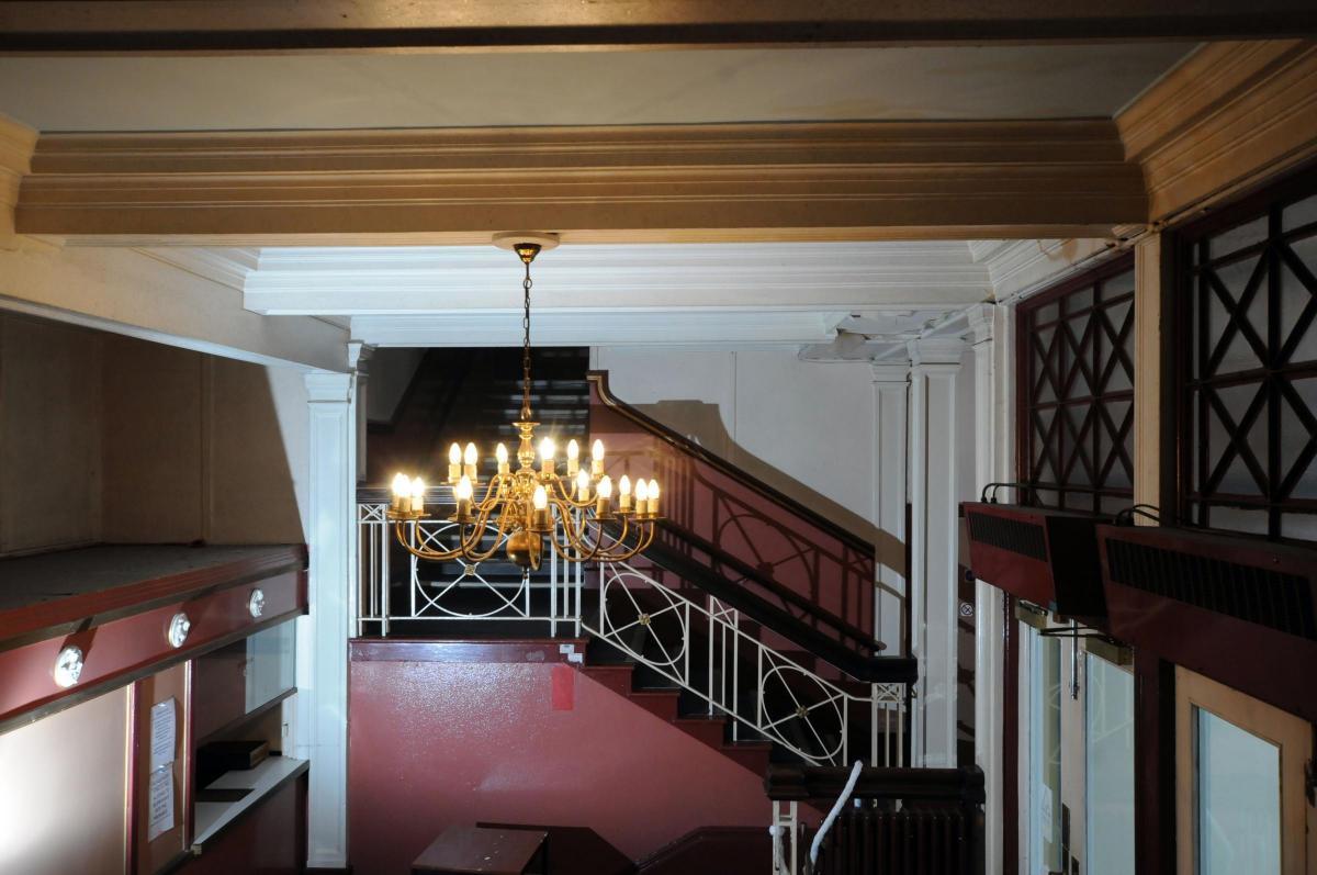 A large chandelier greets people in the entrance foyer