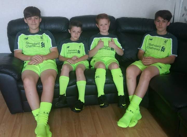 Cason, third from left, with brothers Cowen, Caiden and Corley, sporting their Liverpool shirts