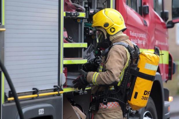 Firefighters wearing breathing apparatus tackle car fire in  Bewsey