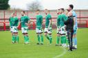 The Vics players and manager Steve Wilkes line up for an emotional tribute to former club secretary Dave Thomas prior to kick-off against Vauxhall Motors. Picture: Angela Buckley