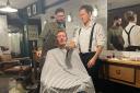 Traditional barber Brent Nile (left) teaches Sweeney Todd actor Joel Merry proper razor technique at Burdett's barber shop in Northwich