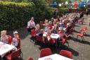 Staff and children at Chrysalis Day Nursery having an early coronation high tea party