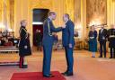 Prince William presents Matthew Lanham with his OBE at Windsor Castle