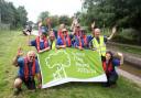 Middlewich Canal and River Trust manager, Paul Reynolds (centre), and volunteers celebrate the Trent and Mersey's new status
