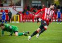 Connor Hughes careers away after scoring Witton's second goal against Hanley Town
