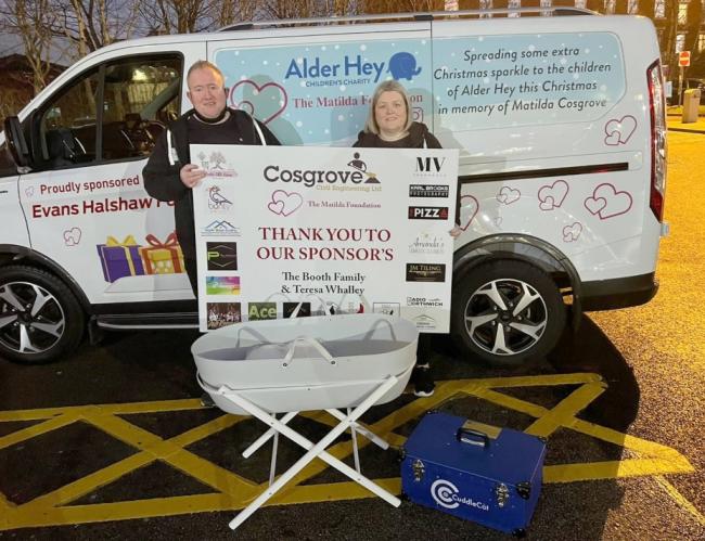 Mark and Stacie Cosgrove deliver a van full of Christmas gifts and a cuddle cot to Alder Hey Children's hospital