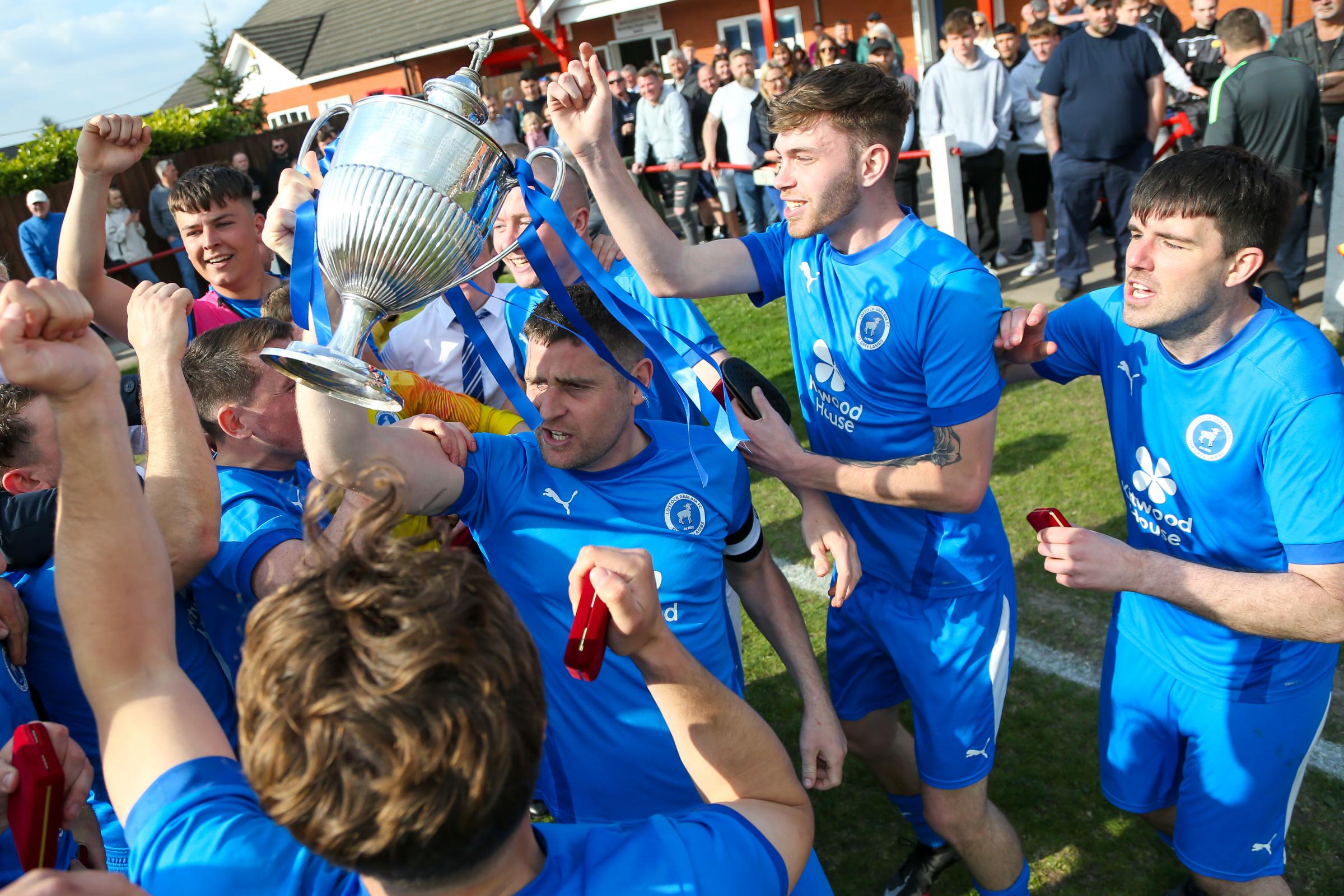 The Lostock Gralam players celebrate with the trophy at full-time. Pictures: Karl Brooks Photography