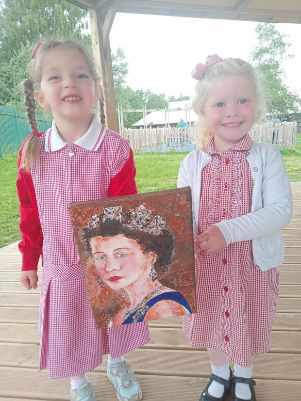 Northwich Guardian: Two of the children show off one of the portraits