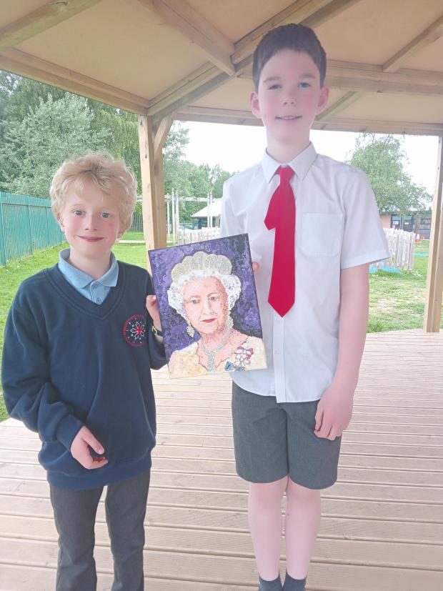 Northwich Guardian: Two of the schoolchildren with one of the Queen's portraits
