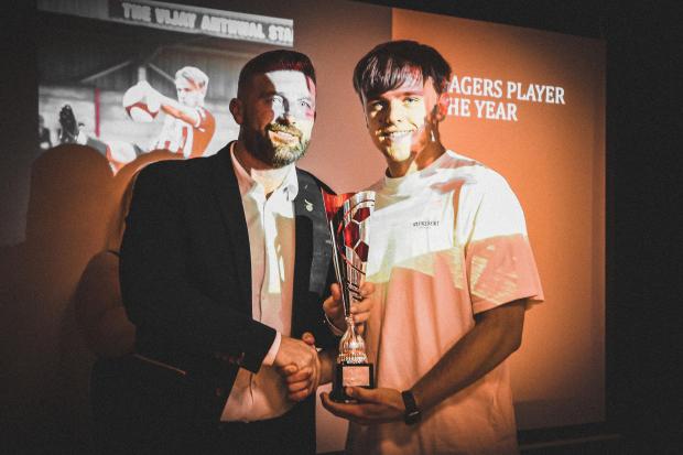 Oli Hitchcox receives the Witton Albion manager's player of the season award from Jon Macken.