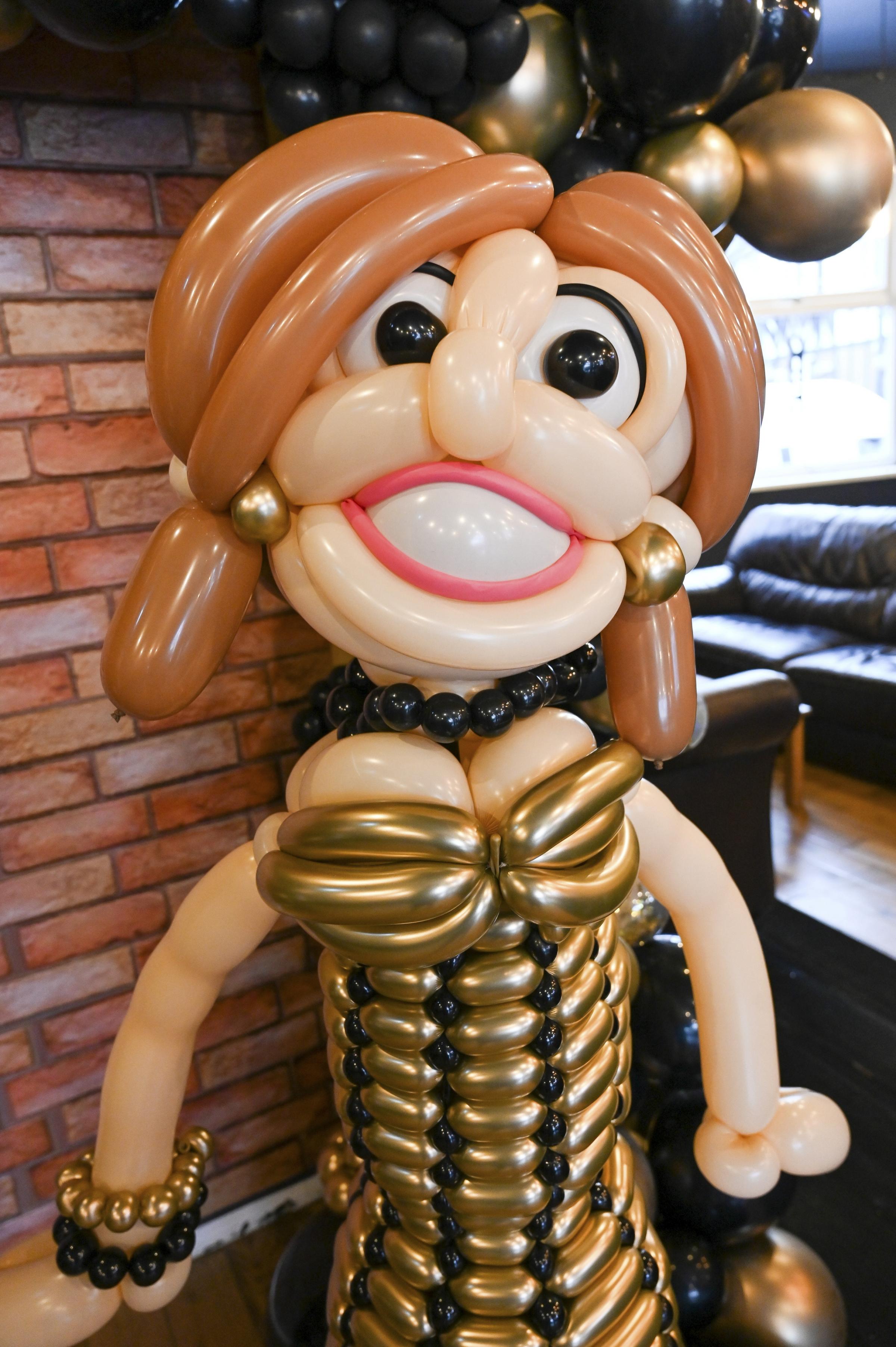 A formal balloon lady dressed in black and gold made at The WOW Shop in Northwich. Picture: SWNS