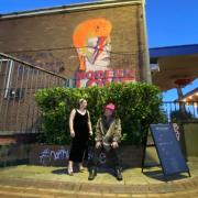 Gallery owner Zoe Briers with artist Trafford Parsons in front of his Bowie mural
