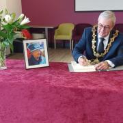 Northwich town mayor Cllr Graham Emmett signs a book of condolence