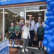 Pupils from St Mary’s Primary School, deputy mayor Simon Whittaker, and wing-walker Vera Rogers at the reopening of the shop