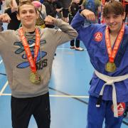 Second Nature Jiu Jitsu members Eben Loftus and Charlie Yates celebrate with their gold medals