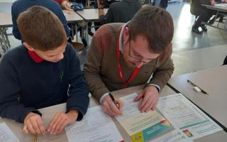 Kingsmead year six pupil Joseph Wilshaw helps Guardian reporter Rob Goulding mark his test paper