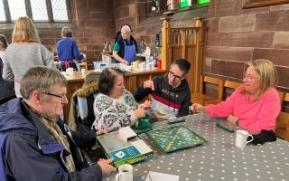 Visitors enjoy a game of Scrabble at the Place of Welcome event