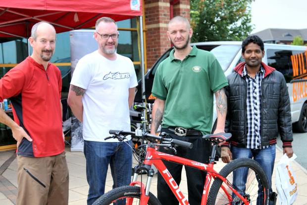Steve Hall, from Gadbrook Park's Bike to Work Day, and Richard Wilding, from Wild Bikes, with Mark Bowyer, from Roberts Bakery, who won first prize of a bike for taking part in the initiative and Elangovan Anand, from The Hut, who won third prize.