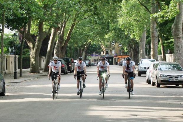 Jim Duffy, far right, and team cycle through London at the end of their 212-mile journey