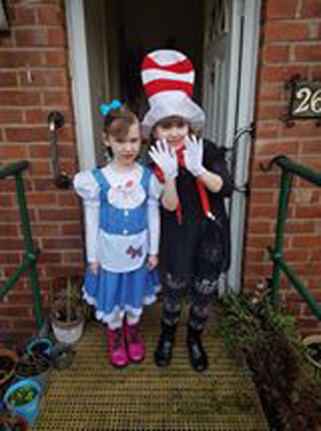 Emily Baguley, seven, cat in the hat and Lillie Baguley, five