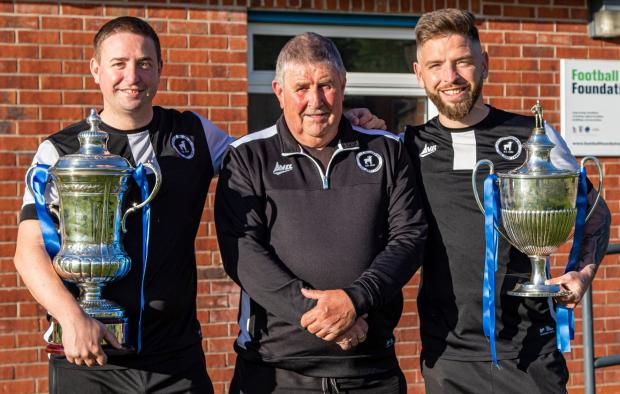 Northwich Guardian: Lostock Gralam co-managers Dean Jones, left, and Dom Johnson show off silverware won by the Grey Lambs this season with chairman Bob Barrow. Picture: Karl Brooks Photography