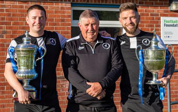 Northwich Guardian: Lostock Gralam co-managers Dean Jones, left, and Dom Johnson show off silverware won by the Grey Lambs this season with chairman Bob Barrow. Picture: Karl Brooks Photography Northwich Guardian: Lostock Gralam co-managers Dean Jones, left, and Dom Johnson show off silverware won by the Grey Lambs this season with chairman Bob Barrow. Picture: Karl Brooks Photography